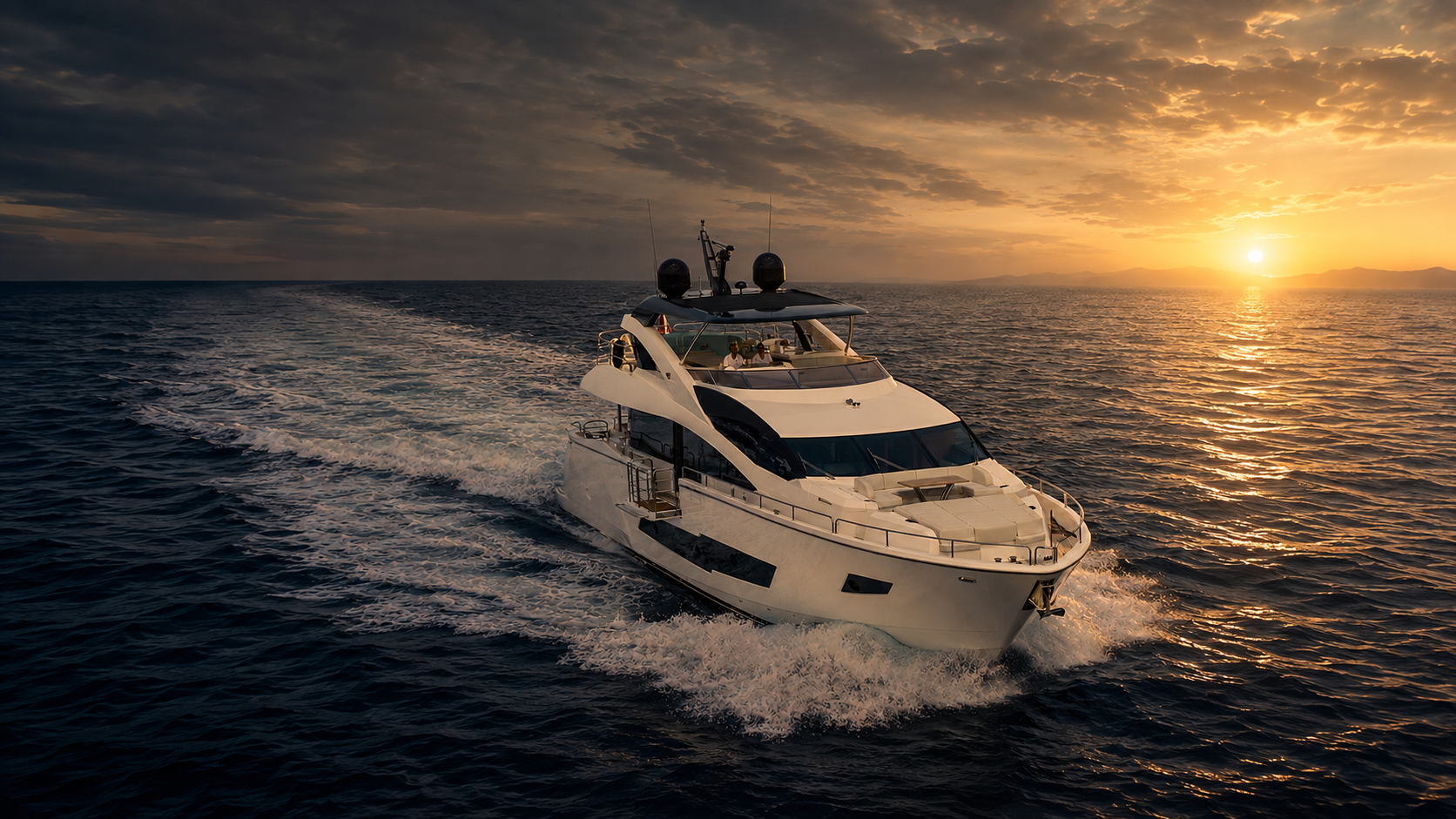 Motor yacht underway on calm Mediterranean water at dawn